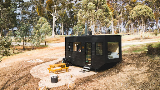 A cabin accommodation at Hahndorf amid towering trees