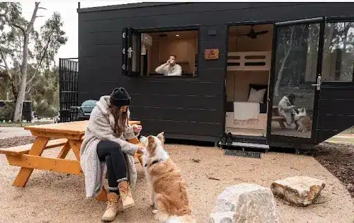couple and their pet in their short-term accommodation in handorf, adelaide hills, sa